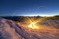 Light painting art. Spinning steel wool in abstract circle, firework showers of bright yellow glowing sparkles on winter snowy