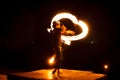 Street artist fire juggling performance. Light painting and long exposure picture to form trails. Phi Phi Island, Thailand.