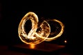 Street artist fire juggling performance. Light painting and long exposure picture to form trails. Phi Phi Island, Thailand.
