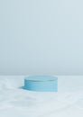 Light, pastel, baby blue 3D rendering minimal product display one luxury cylinder podium or stand on wavy textile product