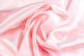 Light pastel pink color silk wavy textile pattern as a smooth textured background. Rose colored soft satin fabric drapery. Royalty Free Stock Photo