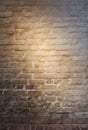 Light patch of light on the old plastered brick wall