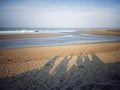 Light and people shadows with raise hands on the beach. Family, friendship togetherness concept. Inspirational backgrounds.