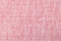 Light pink background from a textile material with wicker pattern, closeup Royalty Free Stock Photo