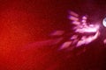 Light pink beams of light on a gradient red finely grained background Royalty Free Stock Photo