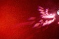 Light pink beams of light on a gradient red finely grained background Royalty Free Stock Photo