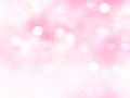 Light pink blurred background.