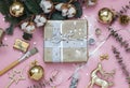 Light pink Christmas, New Year wrapping preparation flay lay with sequins, glitter, gifts, a branch of fir and cotton.