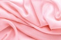 Pink fabric draped with large folds, delicate textile background