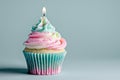 Light pink and light blue cupcake with one candle