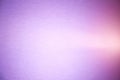 A light pink ray of light cuts through a purple and lilac brutish textural background Royalty Free Stock Photo