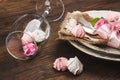 Light pink roses and tableware on the wooden table Royalty Free Stock Photo