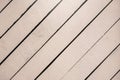 Light pink wooden surface, texture close-up. Rustic natural diagonal planks with cracks, scratches for modern design