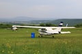 Light plane near a blue barrel of fuel