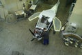 Light planes assembly hall, worker assembling passenger plane