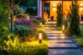 Light posts illuminated backyard garden during night hours. Modern backyard outdoor lighting systems