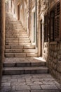 Light pours down a steep narrow Dubrovnik alleyway, Croatia