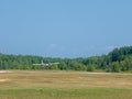 Light private plane is landing on a small airfield on a sunny summer day Royalty Free Stock Photo