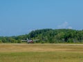 Light private plane is landing on a small airfield on a sunny summer day Royalty Free Stock Photo