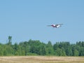 Light private plane is taking off from the runway of a small airfield on a sunny summer day Royalty Free Stock Photo