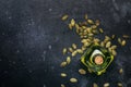 Light pumpkin seeds oil in glass jar on gray kitchen table background, top view