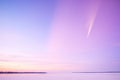 light purple aurora flaring high above horizon