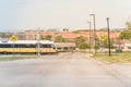 Light rail train speeding through a red alert sign level crossing Royalty Free Stock Photo