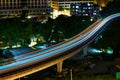 Light rail transit train moving through the city in the night