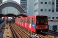 Light railway train approaching the station at Canary Wharf, Lon