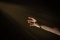 Light Rays Shihing On Man`s Hand In Darkness Royalty Free Stock Photo