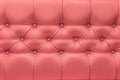 Light red peach colour leather upholstery sofa with pattern button design furniture style decor texture background Royalty Free Stock Photo