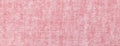 Light red and pink background from a textile material with wicker pattern, macro. Rose fabric with texture Royalty Free Stock Photo