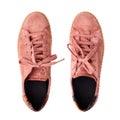 Light red suede sneakers white background isolated close up top view, stylish pink chamois gumshoes, pair of beige leather shoes Royalty Free Stock Photo