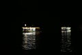 The light reflections of two floating fuel stations on the Amazon river during night time, at the busy port of Manaus, Brazil Royalty Free Stock Photo