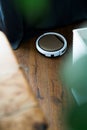 Light robot vacuum cleaner removes dust and dirt in an apartment on a wooden parquet