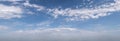 Light scattered clouds across blue sky panorama Royalty Free Stock Photo