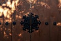 Light and shadow on Korean wooden door panels decorated with old black metallic ring handles at a house in South Korea Royalty Free Stock Photo