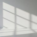 Light and shadow pattern on a plain white wall, formed by sunlight passing through a Royalty Free Stock Photo