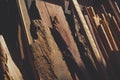 Light and shadow on surface of many old various remaining wooden material used leaning against the wall in storage room Royalty Free Stock Photo