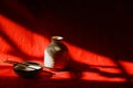 Light and shadows cast on a porcelain container and incense sticks Royalty Free Stock Photo