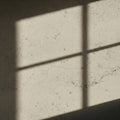 Light and shadows create a grid pattern on a textured, cracked concrete wall. The Royalty Free Stock Photo