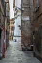 The light and shadows in the empty narrow alleys of Venice  during the coronavirus (with the direction to the WaterTaxi Royalty Free Stock Photo