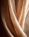 Light shines through textured fabric in warm setting Royalty Free Stock Photo