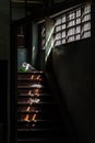 Light shines through the vent shade to wooden staircase in abandoned house Royalty Free Stock Photo