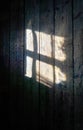 Light shines through a window on the wooden wall background Royalty Free Stock Photo