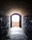 Light shining bright at the end of a dark stone tunnel Royalty Free Stock Photo