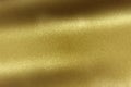 Light shining on brushed gold metal sheet, abstract texture background Royalty Free Stock Photo