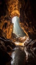 a light shining through a cave Royalty Free Stock Photo