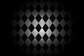 Light shining down on black white rhombus ceramic tile wall in dark room with copy space, abstract background Royalty Free Stock Photo