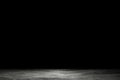 Light shining down on dirt gray cement floor in dark room with copy space, abstract background Royalty Free Stock Photo